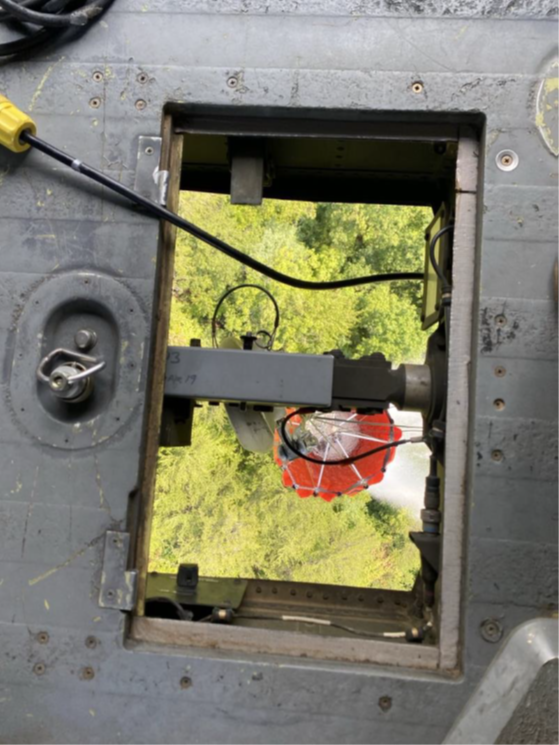 A Tennessee National Guard UH-60 Blackhawk helicopter, from Knoxville’s 1-230th Assault Helicopter Battalion, delivers water with a Bambi Bucket suspended under the aircraft, to fight wildfires in the Great Smoky Mountains National Park, August 27. (submitted Tennessee National Guard photo) 