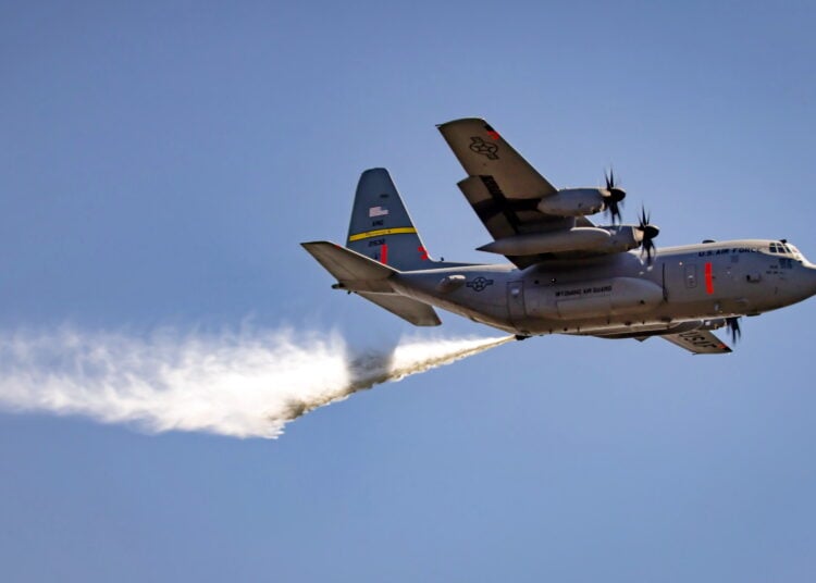 A C-130H-3 Hercules aircraft assigned to the 153rd Airlift Wing releases water over a drop zone during a MAFFS training week at Channel Islands Air National Guard Station, Port Hueneme, California, May 8, 2024. MAFFS training prepares the Air National Guard to combat wildfires alongside the U.S. Forest Service, and this exercise demonstrates the importance of interagency teamwork to support a rapid and efficient response. The aircrew participated in that training and took part in the fight against South California fires in January 2025.  (U.S. Air National Guard photo by Staff Sgt. Kylee Warren)